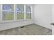 Bright bedroom featuring neutral walls, carpet, and large windows overlooking the landscape at 1215 Corkery Ridge Ct, Cary, NC 27519