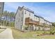 Exterior of gray townhouse featuring a rooftop deck, deck, and backyard at 1215 Corkery Ridge Ct, Cary, NC 27519