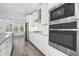 Modern kitchen with stainless steel appliances, white cabinets, and granite countertops at 1215 Corkery Ridge Ct, Cary, NC 27519