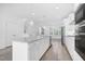 Modern kitchen with stainless steel appliances, white cabinets, and granite countertops at 1215 Corkery Ridge Ct, Cary, NC 27519