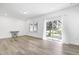 Bright, open-concept living room with hardwood floors, neutral walls, and sliding glass door to the backyard at 1215 Corkery Ridge Ct, Cary, NC 27519