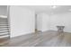 Minimalist living room featuring hardwood floors, neutral walls, and staircase at 1215 Corkery Ridge Ct, Cary, NC 27519