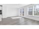 Open-concept living space with wood floors, natural light, and access to the outdoors at 1215 Corkery Ridge Ct, Cary, NC 27519
