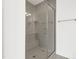 Modern bathroom featuring a glass enclosed shower with gray tile surround, built-in bench and rain head at 1215 Corkery Ridge Ct, Cary, NC 27519