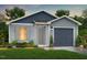 Charming single-Gathering home featuring blue vinyl siding, a covered entryway, and an attached garage at 123 Landon Pl, Roxboro, NC 27573