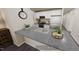 Kitchen with white cabinetry, gray countertop and stainless steel appliances, blending style with modern function at 123 Landon Pl, Roxboro, NC 27573
