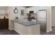 The kitchen is equipped with white cabinetry, stainless steel appliances and a large, stylish countertop at 123 Landon Pl, Roxboro, NC 27573