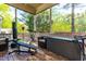 Screened porch with gym equipment and outdoor furniture, perfect for exercise and relaxation at 12308 Bunchgrass Ln, Raleigh, NC 27614