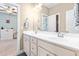 Bathroom featuring a double sink vanity with a large mirror, with doorway views to bedrooms at 12308 Bunchgrass Ln, Raleigh, NC 27614