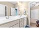 Bathroom featuring a double sink vanity with a large mirror and neutral wall color at 12308 Bunchgrass Ln, Raleigh, NC 27614