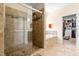 Bathroom with tiled shower and soaking tub, adjacent to a walk-in closet at 12308 Bunchgrass Ln, Raleigh, NC 27614