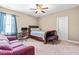 Spacious bedroom with a large bed, desk area, and comfortable seating, perfect for relaxation at 12308 Bunchgrass Ln, Raleigh, NC 27614