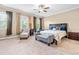 Spacious main bedroom with neutral carpet, ceiling fan, and sitting area at 12308 Bunchgrass Ln, Raleigh, NC 27614