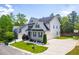 Two-story home showcasing well-maintained landscaping and expansive driveway at 12308 Bunchgrass Ln, Raleigh, NC 27614
