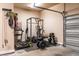 Finished garage with a home gym featuring a treadmill, weights, and other workout equipment at 12308 Bunchgrass Ln, Raleigh, NC 27614