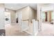 Upstairs hallway with a laundry room, light walls, and open doorways at 12308 Bunchgrass Ln, Raleigh, NC 27614