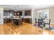 Well-lit kitchen with dark wood cabinetry, stainless steel appliances, and eat-in breakfast nook at 12308 Bunchgrass Ln, Raleigh, NC 27614