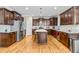 Bright kitchen featuring stainless appliances, dark wood cabinets, and hardwood floors at 12308 Bunchgrass Ln, Raleigh, NC 27614