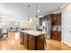 Spacious kitchen features a center island, stainless steel appliances, and hardwood floors at 12308 Bunchgrass Ln, Raleigh, NC 27614
