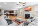 Comfortable living room with a fireplace, large screen television and hardwood floors throughout at 12308 Bunchgrass Ln, Raleigh, NC 27614