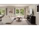 Inviting living room with large windows, stylish furnishings, and ample natural light at 129 Lillian Ct, Roxboro, NC 27573