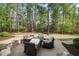 Backyard patio with stone retaining wall and outdoor seating at 1305 Reservoir View Ln, Wake Forest, NC 27587