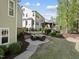 Expansive backyard featuring a stone patio, lush landscaping, and a fenced perimeter at 1305 Reservoir View Ln, Wake Forest, NC 27587