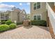 Brick-paved backyard featuring an outdoor grill and seating area, perfect for entertaining at 1305 Reservoir View Ln, Wake Forest, NC 27587