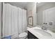 Well-lit bathroom with shower/tub combo, white marble vanity, and decorative framed artwork at 1305 Reservoir View Ln, Wake Forest, NC 27587