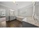 Beautiful bathroom showcasing a large soaking tub, granite counters, and gray cabinets at 1305 Reservoir View Ln, Wake Forest, NC 27587