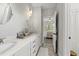 Bright bathroom with double vanity sinks, granite countertops, and an open view to the bedroom at 1305 Reservoir View Ln, Wake Forest, NC 27587
