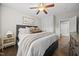 Comfortable bedroom boasts a plush bed with layered pillows and throw, adjacent to a small side table at 1305 Reservoir View Ln, Wake Forest, NC 27587