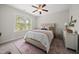 Inviting bedroom featuring a window, upholstered headboard, and a patterned rug at 1305 Reservoir View Ln, Wake Forest, NC 27587