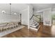 Bright dining room with a modern light fixture and hardwood floors at 1305 Reservoir View Ln, Wake Forest, NC 27587