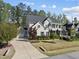 Beautiful two-story home with a long driveway, lush landscaping, and attached garage at 1305 Reservoir View Ln, Wake Forest, NC 27587