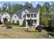 Charming two-story home features a welcoming porch and manicured lawn, creating a picturesque and inviting curb appeal at 1305 Reservoir View Ln, Wake Forest, NC 27587