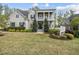 Inviting two-story home with a manicured lawn, mature trees, and a charming front porch at 1305 Reservoir View Ln, Wake Forest, NC 27587