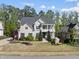 Charming two-story home with a landscaped yard and a welcoming double porch at 1305 Reservoir View Ln, Wake Forest, NC 27587