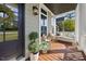 Cozy front porch with a swing, comfortable seating, and stylish decor at 1305 Reservoir View Ln, Wake Forest, NC 27587