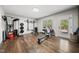This home gym features wood floors, exercise equipment, and natural light at 1305 Reservoir View Ln, Wake Forest, NC 27587