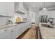 Modern kitchen featuring white cabinetry, granite countertops, and stainless steel appliances at 1305 Reservoir View Ln, Wake Forest, NC 27587