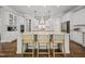 Gourmet kitchen with white cabinetry, granite countertops, stainless steel appliances, and island seating at 1305 Reservoir View Ln, Wake Forest, NC 27587