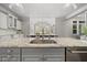 Modern kitchen features gray cabinets, granite countertops, stainless steel appliances, and an open floor plan at 1305 Reservoir View Ln, Wake Forest, NC 27587