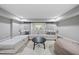 Bright living room features a white sectional sofa, a black coffee table, and a comfortable beanbag chair at 1305 Reservoir View Ln, Wake Forest, NC 27587