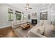 Bright living room with a fireplace, built-in shelving, and an open view to the porch at 1305 Reservoir View Ln, Wake Forest, NC 27587