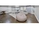 Comfortable living room features hardwood floors, a large sectional sofa, and stylish sliding barn doors at 1305 Reservoir View Ln, Wake Forest, NC 27587