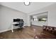 Spacious office features a desk, chair, and a view of the adjacent Gathering room with a white sectional sofa at 1305 Reservoir View Ln, Wake Forest, NC 27587