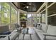 Relaxing screened porch with a fireplace, TV, comfortable seating, and views of the outdoors at 1305 Reservoir View Ln, Wake Forest, NC 27587