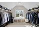 Spacious walk-in closet with custom shelving, bench seat, and ample storage space at 1305 Reservoir View Ln, Wake Forest, NC 27587
