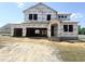 New construction home featuring a large attached garage with a covered front porch at 139 Fast Pitch Ln, Four Oaks, NC 27524